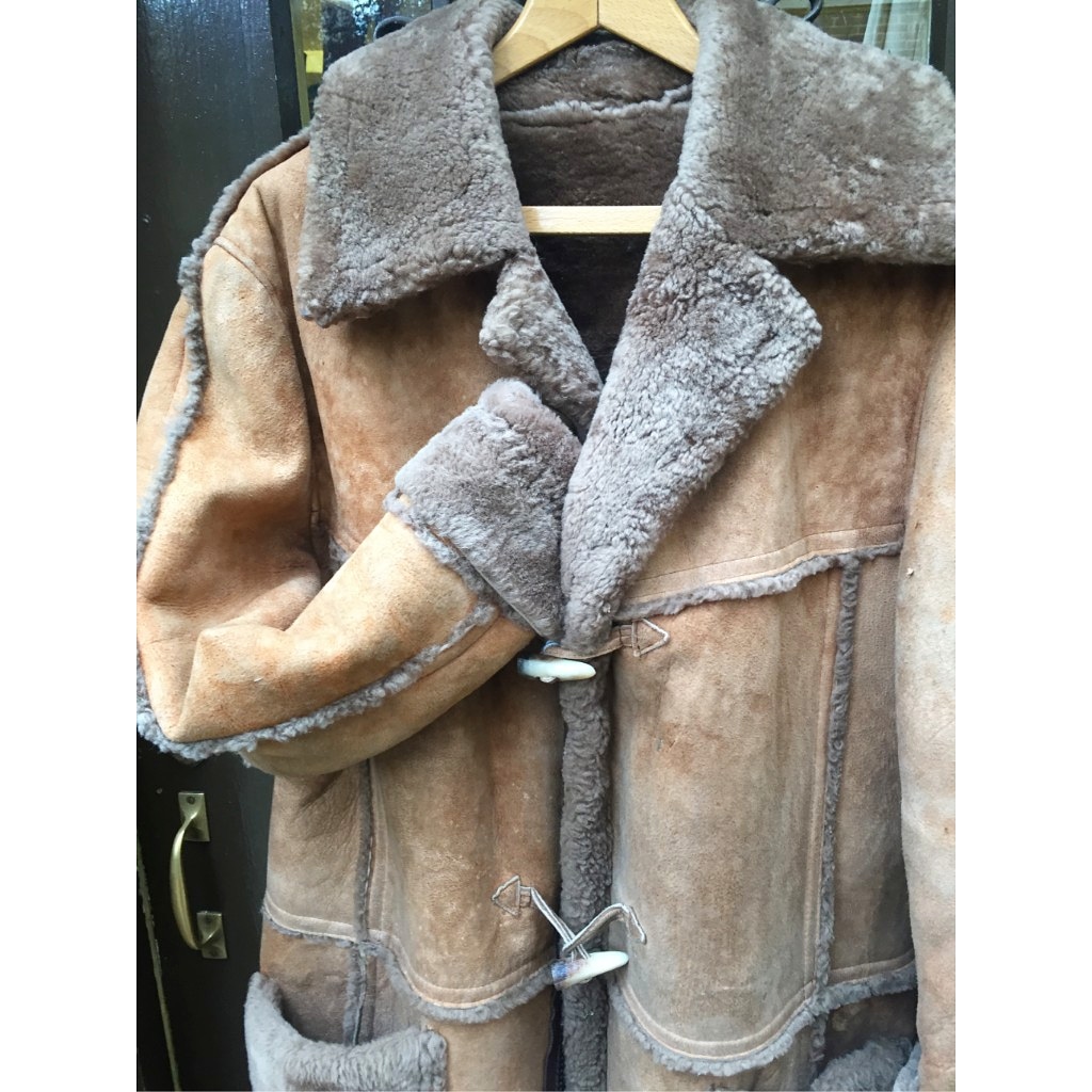 A 1970’s faded light tan shearling sheepskin coat, made in England by ...